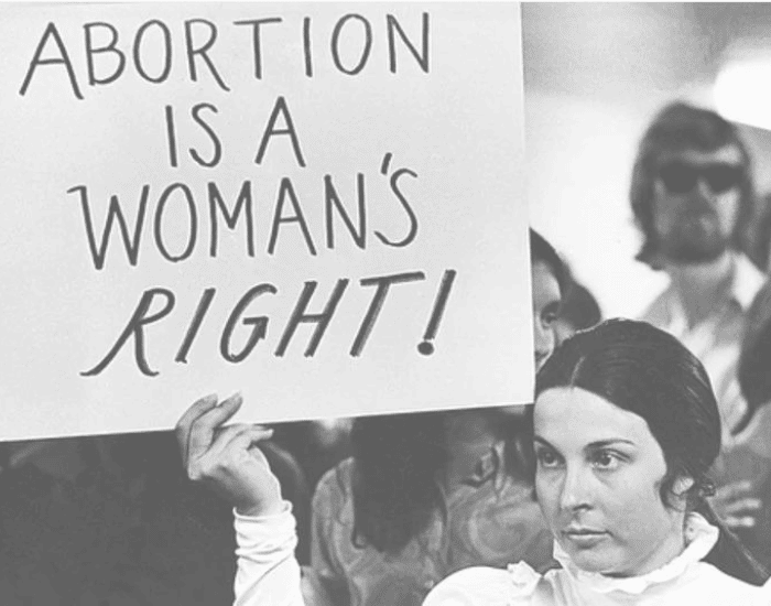 woman holding a placard about abortion