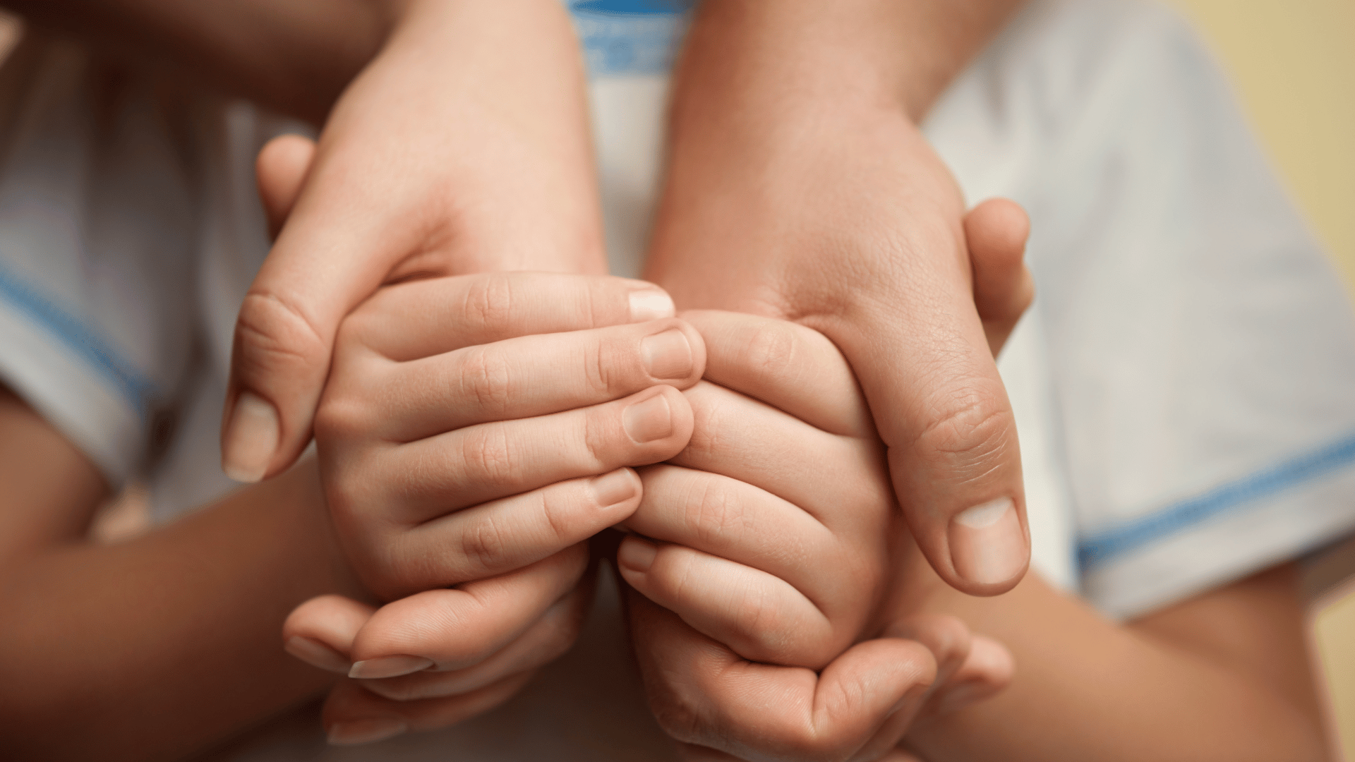 Childs hands enclosed in older person's hands. Children's Court: Care Protection Lawyers. Child Protection Lawyers Sydney. Domestic Violence Lawyers Sydney.