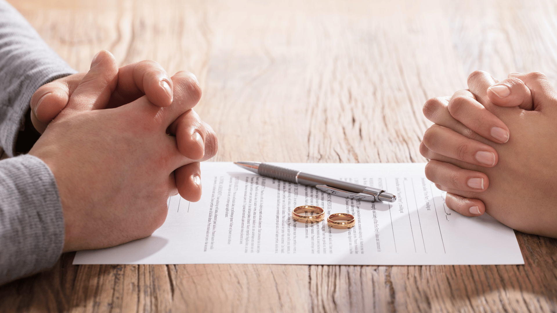 separating couple's hands on opposing sides of a table. Divorce Lawyer Penrith. Family solicitors Sydney. Family Lawyers Sydney.